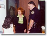 CAST team members including officer talking with a child. Children pictured are child actors