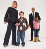 Image of mom standing with son and father standing with daughter.