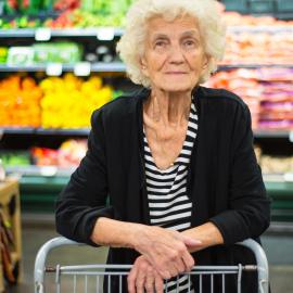 An elderly woman grocery shops